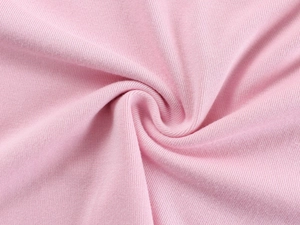 Macro shot of soft pink knitted cotton fabric showing detailed texture and smooth weave