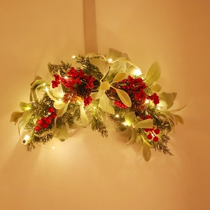 Christmas door swag with red berries, pine needles, and warm LED lights for home decor