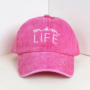 Detail of mom LIFE white embroidery on washed fuchsia pink cotton baseball cap