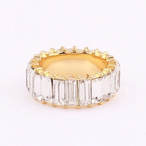 Detailed macro view of gold-plated eternity ring with rectangular baguette-cut cubic zirconia