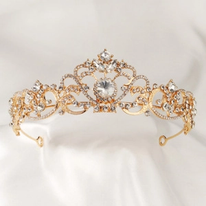 Detail of vintage gold bridal tiara with intricate scrollwork and sparkling rhinestones