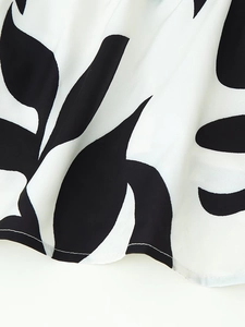 Macro detail of breathable black and white leaf print fabric with premium stitching