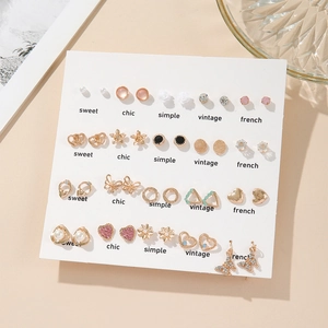 Detail of 20 pairs earring set with heart pearls and crystals on a white display card