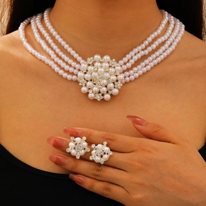 Detailed close-up of a French vintage pearl necklace set with a central crystal flower pendant