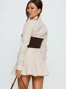 Detail view showing a striped long sleeve shirt with a stylish brown knit waist corset