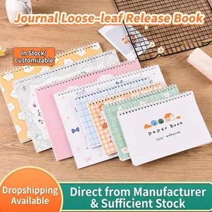 Spiral-bound release paper scrapbooks with diverse aesthetic covers on a wooden desk