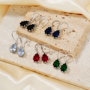 Elegant water-drop pendant earrings in multiple colors on beige stone and satin background