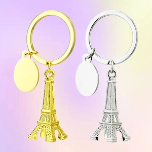 3D Eiffel Tower metal keychains in gold and silver with blank round tags for engraving