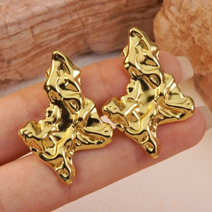 Golden irregular lava textured earrings with a bold liquid metal geometric design