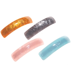 Set of four colorful marbled acetate hair clips in gold, grey, pink, and blue shades