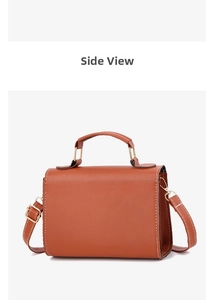 Side view of caramel brown leather crossbody bag featuring white contrast stitching and gold hardware