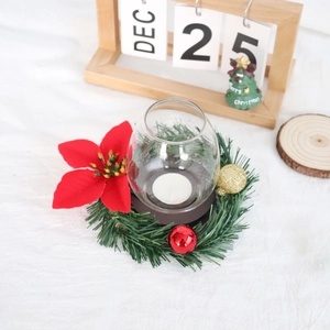 Close-up of a festive Christmas candle holder with red poinsettia and wood base