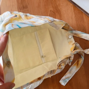 Detail view of cotton tote bag interior showing zipper pocket and magnetic snap closure