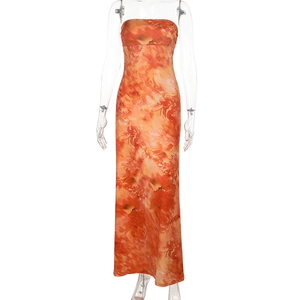 Detail of orange abstract print strapless maxi dress with a silky satin texture