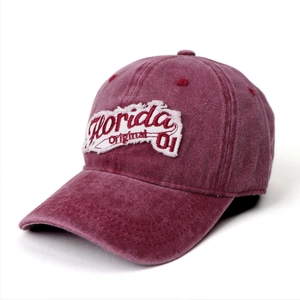 Close-up of vintage washed wine red denim baseball cap with Florida embroidery detail