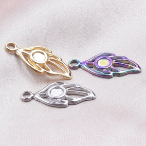 Detailed view of leaf-shaped stainless steel pendant bases in gold silver and rainbow finishes