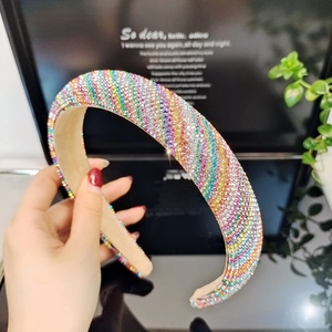 Detail of colorful rhinestone headband with rainbow sparkles and soft inner padding