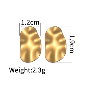 Detail view of gold heart earrings with 1.2cm width and 1.9cm height measurements