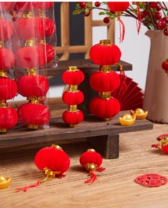 Close-up of traditional red flocked lanterns with gold accents and lucky red tassels
