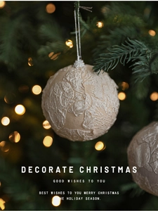 Detailed macro view of cream lace fabric texture on Christmas ball ornament hanging on tree