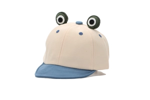 Detail of baby cartoon frog baseball cap showing 3D eyes and breathable cotton fabric