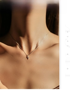 Macro detail of S925 silver lightning bolt pendant with sparkling zircons on fine chain