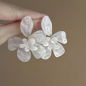 Elegant white translucent resin flower earrings with marble texture and gold hooks