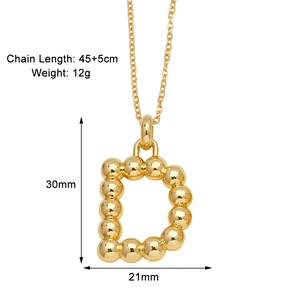 Macro detail of the golden letter D pendant showing dimensions and polished finish