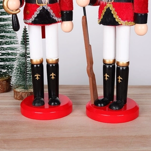 Close-up of wooden nutcracker base and fabric uniform details on festive tabletop