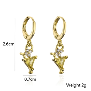 Detailed view of 18K gold cocktail glass earrings with yellow zircon and crystal stones