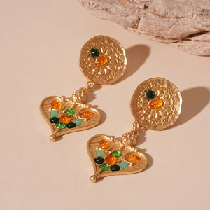 Detailed macro view of vintage heart-shaped earrings with colorful resin bead accents