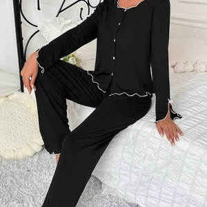 Women's black long-sleeved pajamas set with white lettuce edge trim and button front