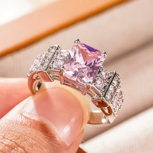 Macro shot of rectangular pink gemstone ring with delicate pave setting details
