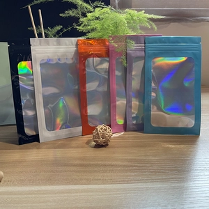 Variety of colorful holographic resealable bags with window displayed on a wooden surface