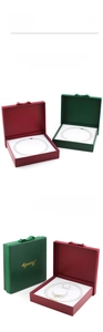 Close-up of elegant leather jewelry boxes with ribbon bows and white velvet interior lining