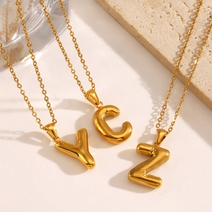 Golden balloon style initial necklace with letters Y C Z on a polished O-chain