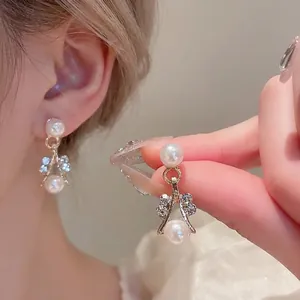 Elegant gold pearl earrings with sparkling rhinestones and a wishlist bone curve design