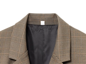 Détail du revers classique et du tissu à carreaux marron d'un blazer décontracté femme