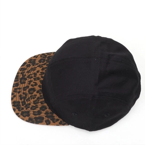 Top view of five-panel cap with black canvas body and classic leopard print flat brim