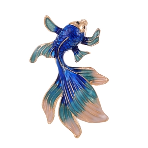 Detailed shot of an enamel goldfish brooch with vibrant blue and green gradient colors