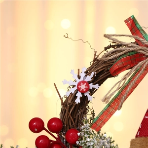 Close-up of Christmas wreath with dried vine base, red berries and plaid bow details