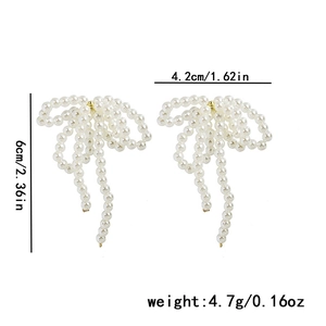 Detail showing dimensions of 4.2cm by 6cm for pearl bow tassel long earrings