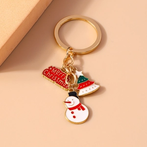 Christmas keychain with enamel pendants featuring a snowman and green Xmas tree