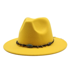 Detail of yellow wool fedora hat with bohemian woven band and turquoise bead decor