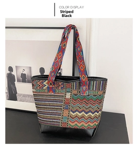 Detail of striped black ethnic tote bag showing colorful geometric weave and leather straps