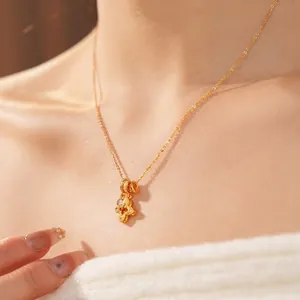 Golden hollow four-leaf flower pendant necklace with shimmering zircon for women