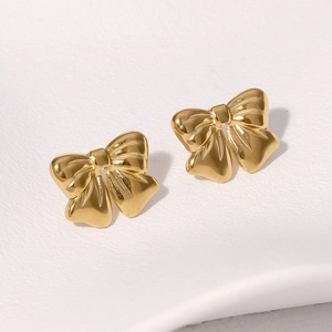 Elegant gold bow-shaped stainless steel stud earrings shown on a clean white background