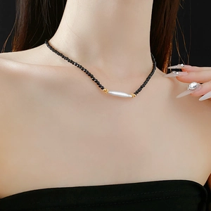 Detail of French vintage necklace with black crystal beads and white freshwater pearl
