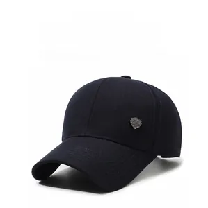 Detail of navy blue baseball cap showing breathable fabric texture and silver shield logo