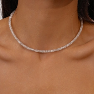 Close-up of a silver mesh choker necklace with zircon geometric circles on a model